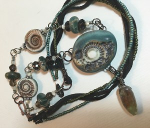 the loosely braided back of the piece - seed beads and leather